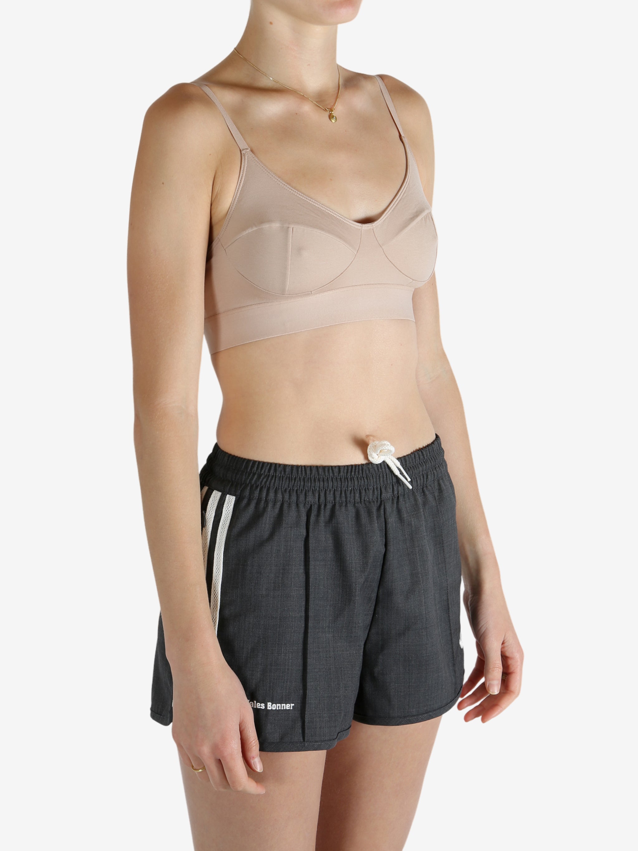 Tan top worn by a person, showing the top's fit