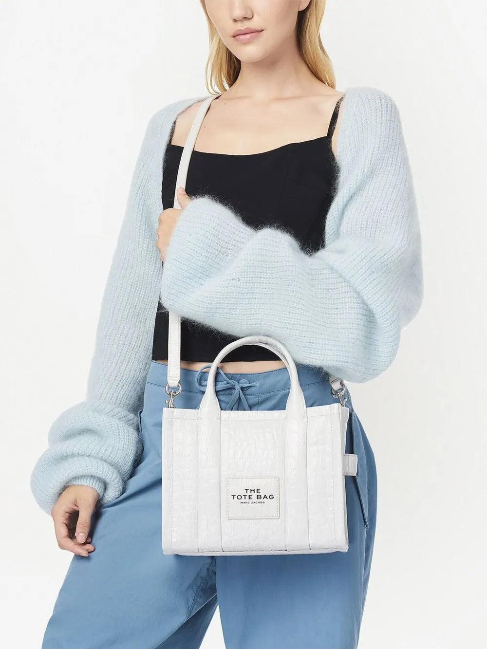 White bag carried by a person, showing the bag's fit