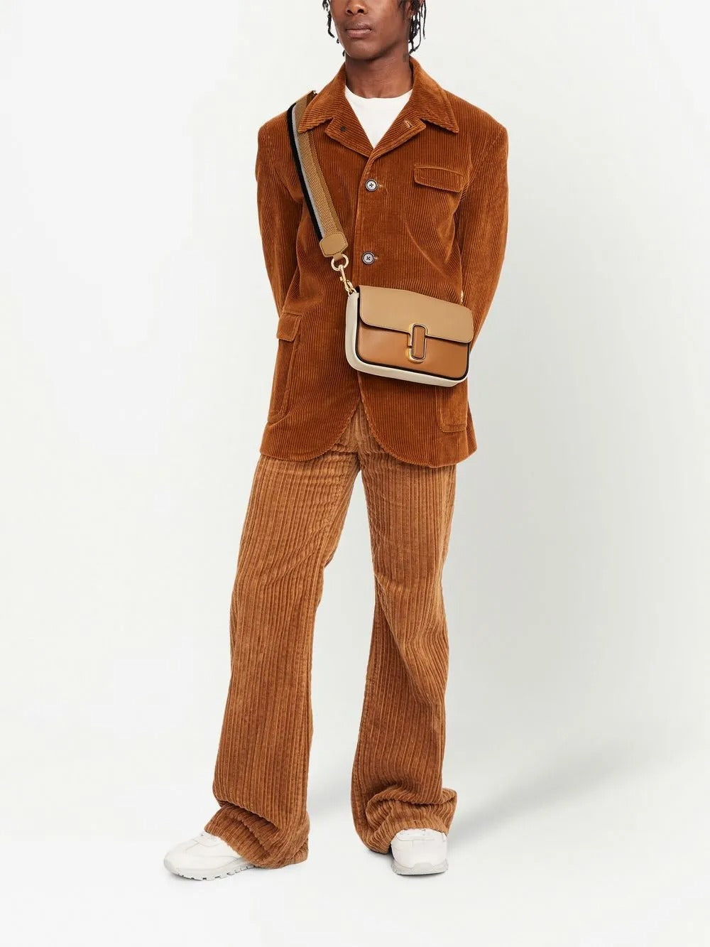 Tan bag carried by a person, showing the bag's fit