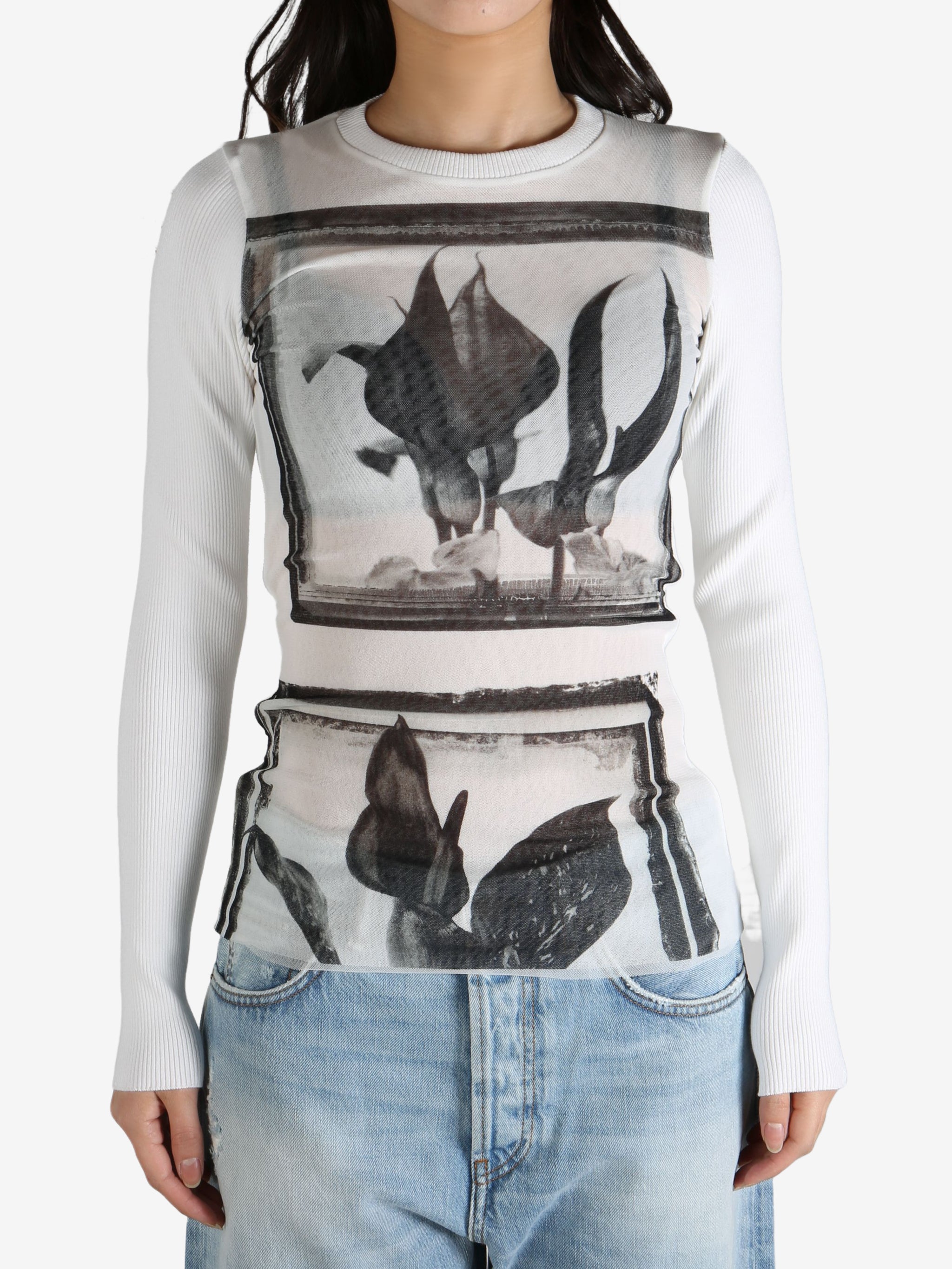 White top worn by a person, showing the top's fit