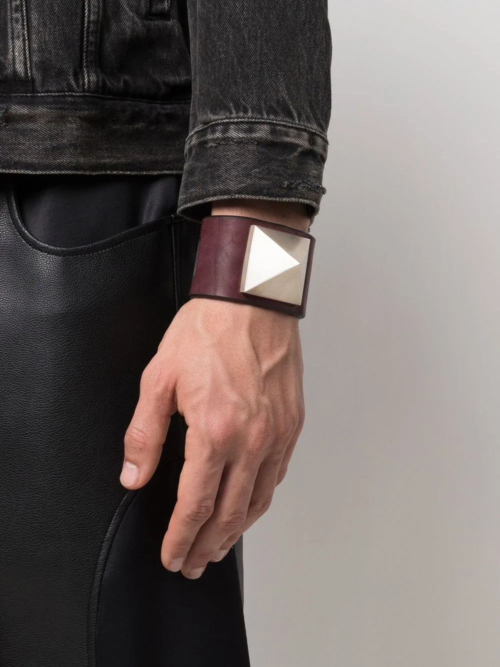 Red bracelet worn by a person, showing the bracelet fit