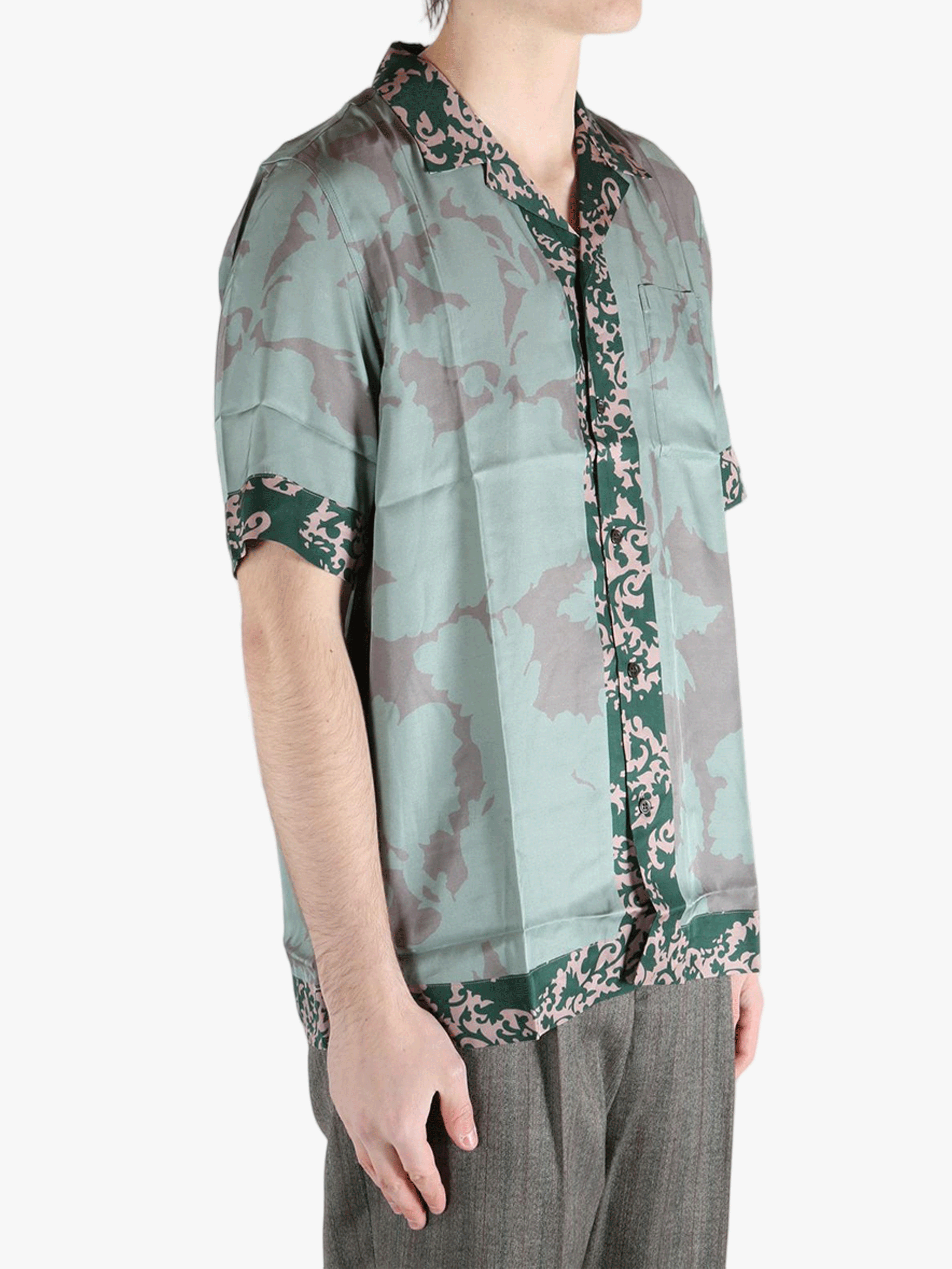 green shirts worn by a person, showing the shirts fit