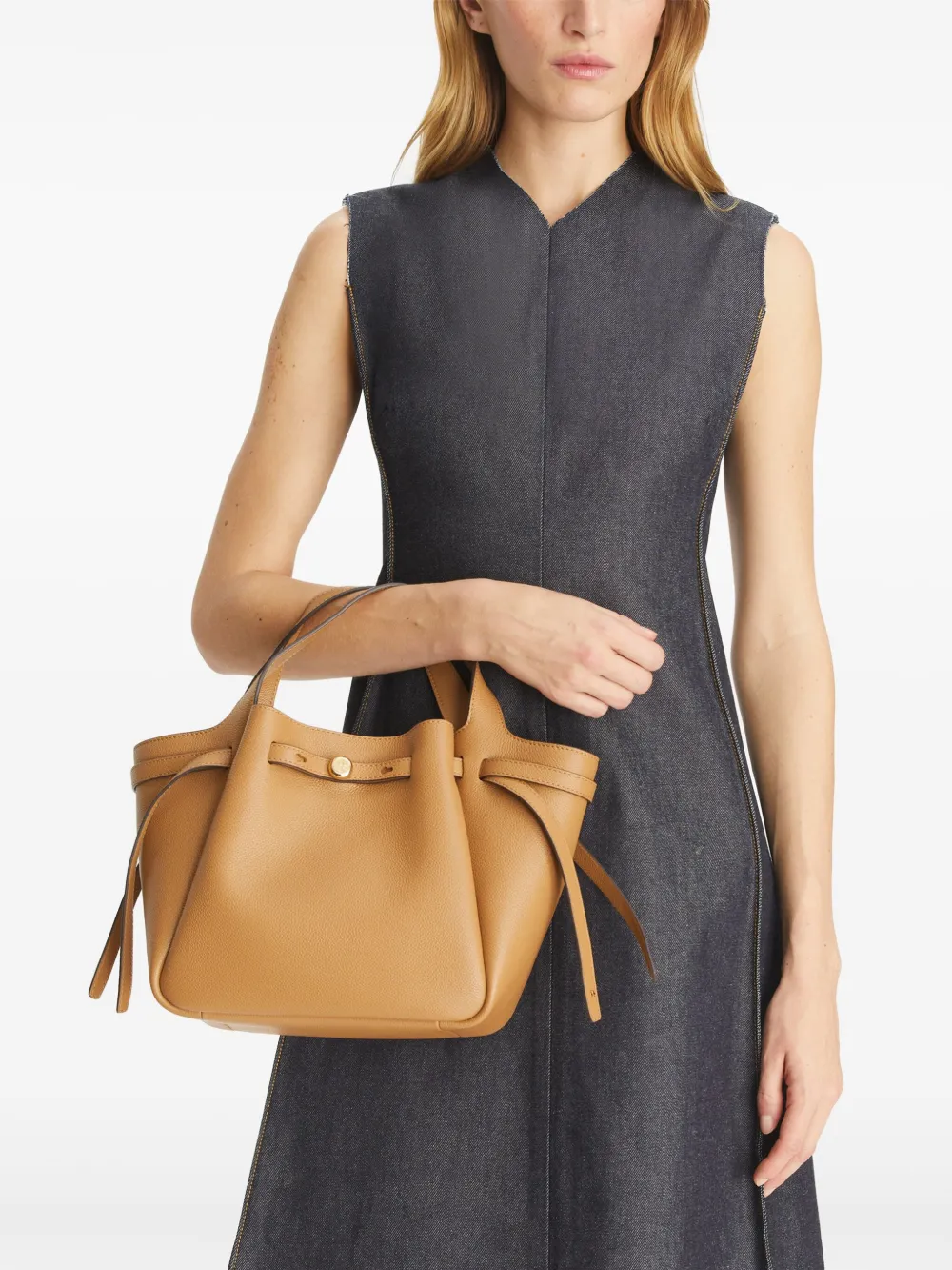 brown bags worn by a person, showing the calf Leather fit